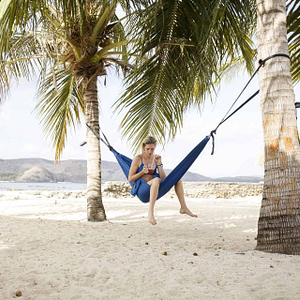 blue hammock strapped between trees